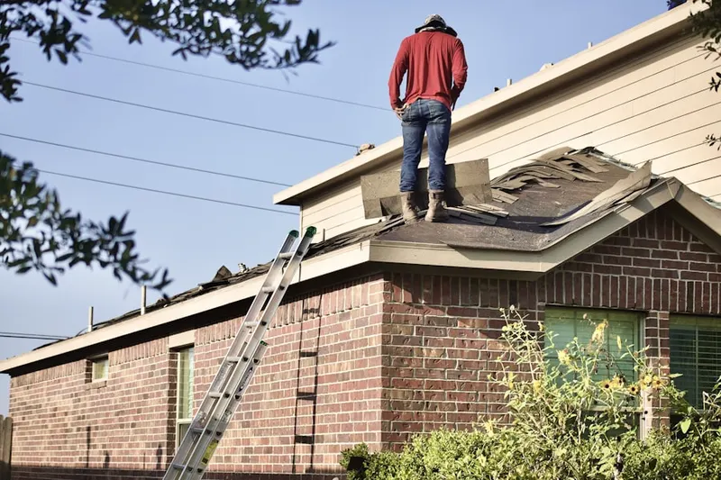 Professional roofer working on a residential roof in Minden